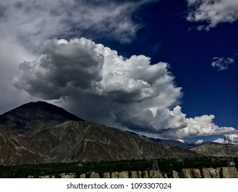 Cumulus clouds develop over Karakoram mountain range during late spring rainy season in Gilgit-Baltistan, Pakistan. - Powered by Shutterstock - Get 15% off with code: PIKWIZARD15