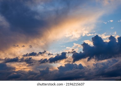 Cumulus Clouds On Evening Sky Backlit With Sunset. Captured With 70mm Lens On 35mm Full-frame Sensor Camera.