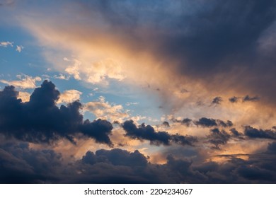 Cumulus Clouds On Evening Sky Backlit With Sunset. Captured With 70mm Lens On 35mm Full-frame Sensor Camera.