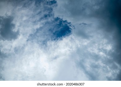 Cumulus clouds in the rays of the evening sun. Clouds against the blue sky. Texture for the background.