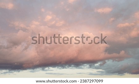 Cumulus clouds with a reddish tint
