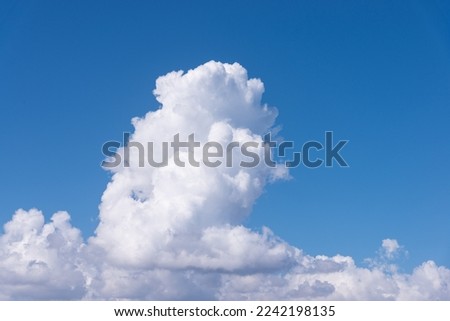Cumulus white clouds in clear blue sky background