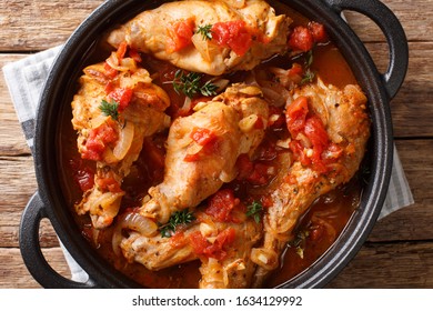 Cunillo Stew Of Rabbit In Tomato Sauce With White Wine And Herbs Close-up In A Pan On The Table. Horizontal Top View From Above
