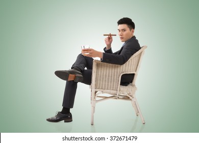 Cunning Businessman Of Asian Sit On Chair.