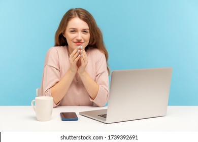 Cunning Woman Employee With Tricky Face Scheming And Conspiring Sitting At Workplace In Office, Thinking Devious Sly Business Plan, Sneaky Idea In Mind. Indoor Studio Shot Isolated On Blue Background