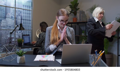 Cunning Young Adult Professional Business Woman Company Director Rubbing Hands, Scheming Evil Tricky Prank Plan In Mind, Smiling In Office Interior. Clever Girl Robber Pondering Ominous Revenge, Cheat