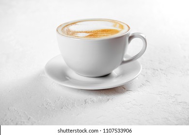 Cup of art latte on a cappuccino coffee on white background