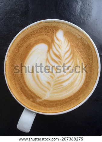 Cup of art latte on a cappuccino coffee