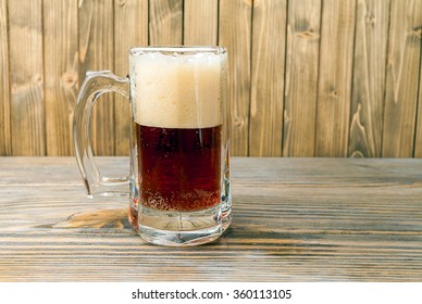 cup of beer on wood.