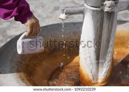 Cup being filled with hot spring water in Carlsbad (Karloff Vary), Czech Republic