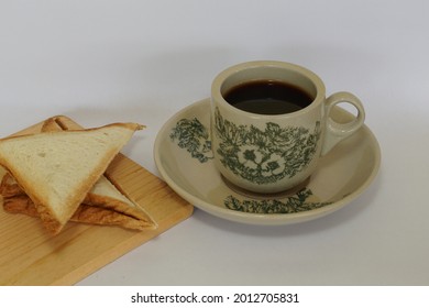 a cup of black coffee with bread