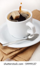 Cup Of Black Coffee With A Cube Of Brown Sugar