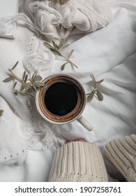 A Cup Of Black Coffee And Green Leaves Scattered On White Sheet. Aesthetic Concept