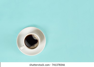 A Cup Of Black Coffee On Blue Background. View From Above.