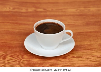 A cup of black coffee in wooden table  - Shutterstock ID 2364469613