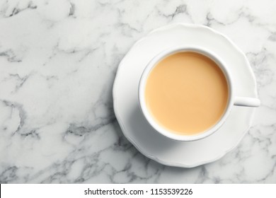 Cup With Black Tea And Milk On Marble Table, Top View