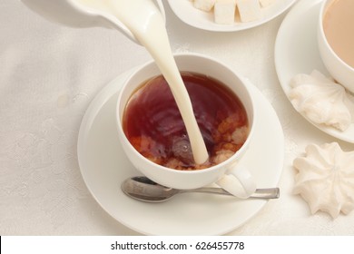 Cup Of Black Tea With Milk / Tea Pouring