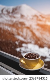 cup with brown coffee beans on mountain background - Shutterstock ID 2368784315