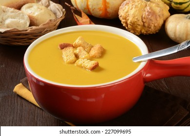 A Cup Of Butternut Squash Soup With Pumpkin Cornbread Croutons