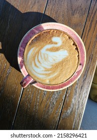 A cup of cappuccino with beautiful latte art - a swan, good for morning wake up