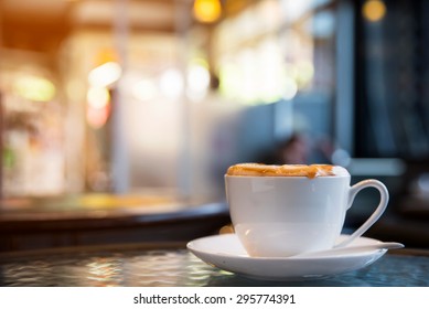 Cup Of Cappuccino With Blur Coffee Shop Background 