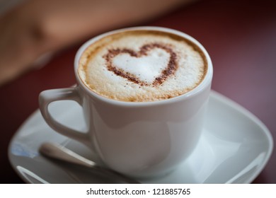 cup of cappuccino coffee, chocolate heart on top - Shutterstock ID 121885765