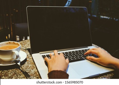 A Cup Of Cappuccino Coffee With Laptop On Table. Royalty High Quality Free Stock Image Of Capuccino Coffee With Laptop For Working In A Coffee Shop. Beautiful Workspace With Retro And Vintage Style  