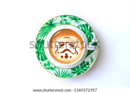 cup of cappuccino coffee with a stormtrooper pattern on milk crema