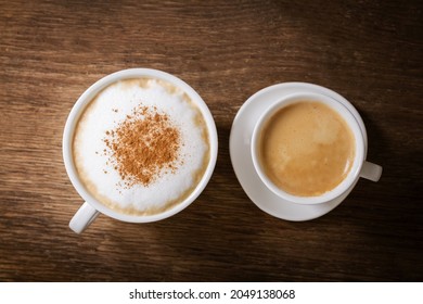 Cup Of Cappuccino And Cup Of Espresso On A Wooden Background, Top View