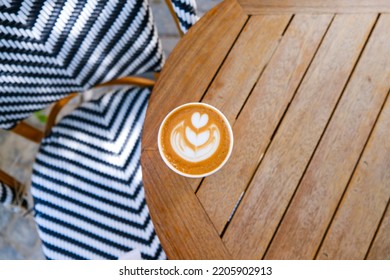 Cup Of Cappuccino To Go On The Wooden Table With Latte Art. Street Coffee, Top View.