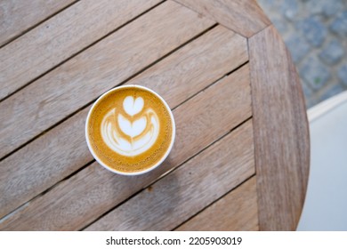 Cup Of Cappuccino To Go On The Wooden Table With Latte Art. Street Coffee, Top View.