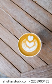 Cup Of Cappuccino To Go On The Wooden Table With Latte Art. Street Coffee, Top View.