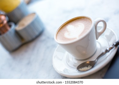 Cup Of Cappuccino With Latte Art On Marbel Cafe Table, Selective Focus.