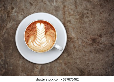 Cup Of Cappuccino With Perfect Latte Art On The Table. Top View, Macro.