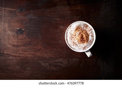 Cup Of Cappuccino Topped With Cocoa; Seen From Above