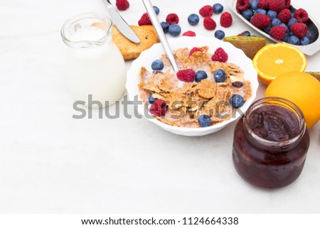 cup of cereals with fruits and milk, balanced and healthy breakfast