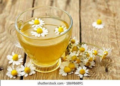 cup of chamomile tea with chamomile flowers  