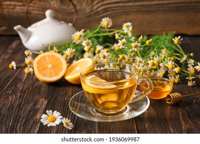 Cup of chamomile tea on wooden background