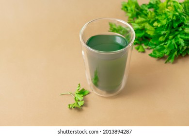 Cup Of Chlorophyll Water On Light Beige Background With Copy Space