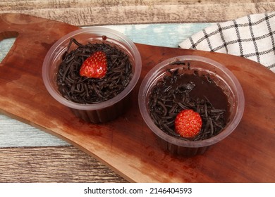a cup of chocolate pudding on the table