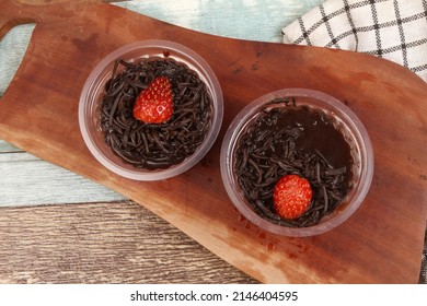 a cup of chocolate pudding on the table