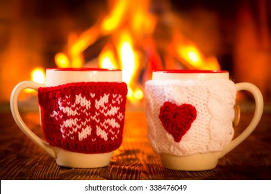 Cup With Christmas And Valentine Ornament Near Fireplace. Winter Holiday Concept. Couple, Love, Valentine's Day