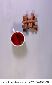 A Cup Of Cinnamon Tea And Cinnamon Sticks. Overhead Shot