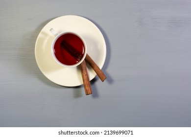 A Cup Of Cinnamon Tea And Cinnamon Sticks. Overhead Shot