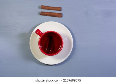 A Cup Of Cinnamon Tea And Cinnamon Sticks. Overhead Shot