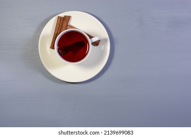 A Cup Of Cinnamon Tea And Cinnamon Sticks. Overhead Shot