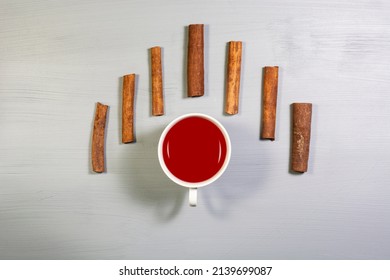 A Cup Of Cinnamon Tea And Cinnamon Sticks. Overhead Shot