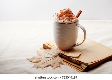 Cup of cocoa with cinnamon, whipped cream and chocolate. Textile background. Scandinavian winter concept. Horizontal composition with copy space. - Powered by Shutterstock