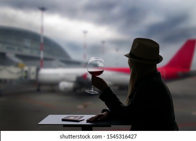 Cup Of Coffee In Airport.Airline Passenger In An Airport Lounge Waiting For Flight Aircraft. Caucasian Woman With Glass Wine.