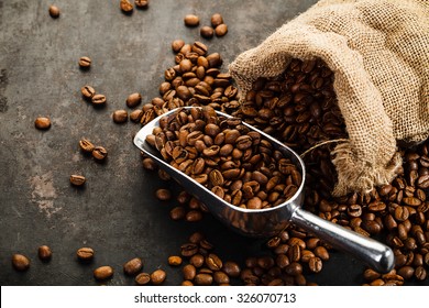 Cup of coffee, bag and scoop on old rusty background - Shutterstock ID 326070713